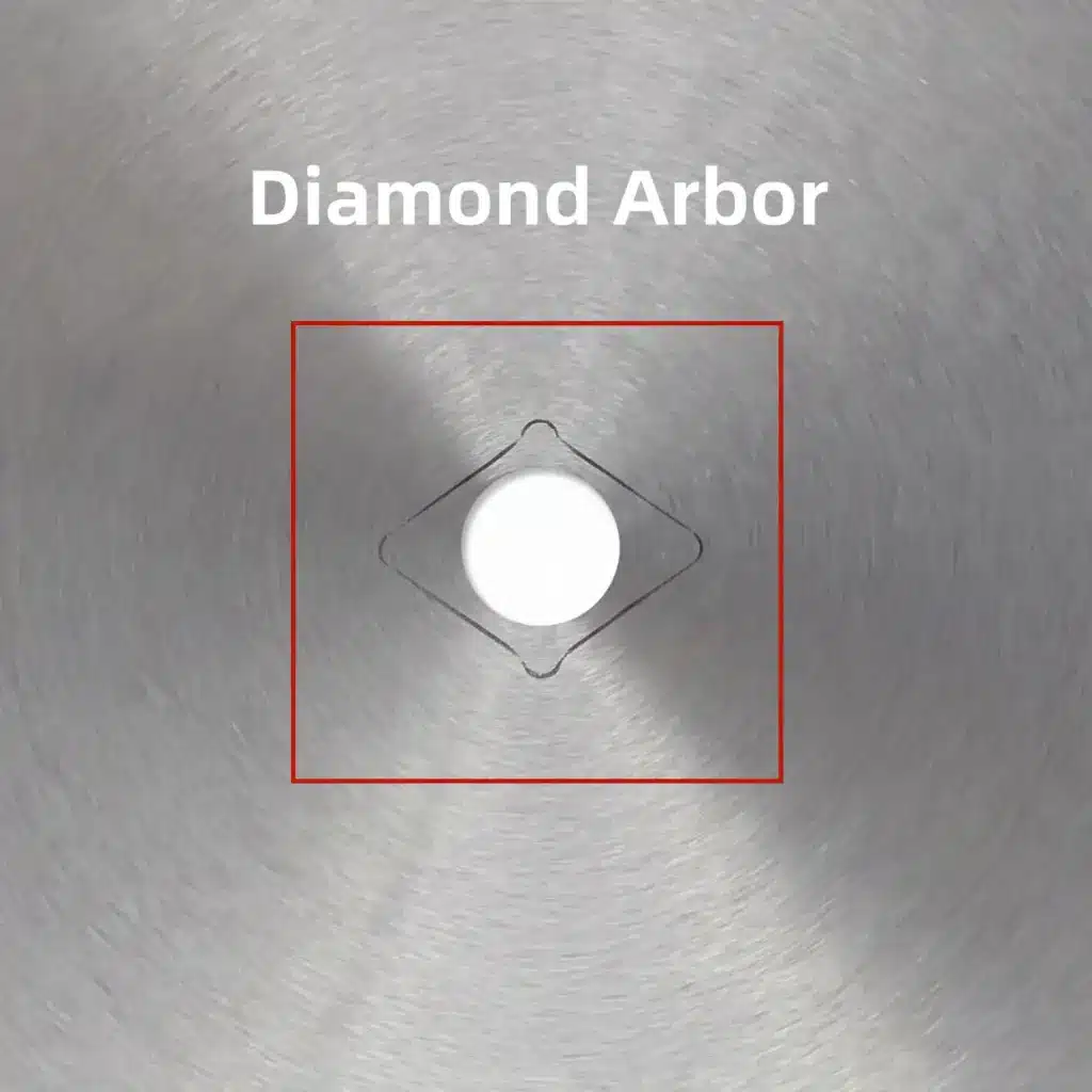 Close-up of a metal circular saw blade center featuring a diamond arbor knockout hole.